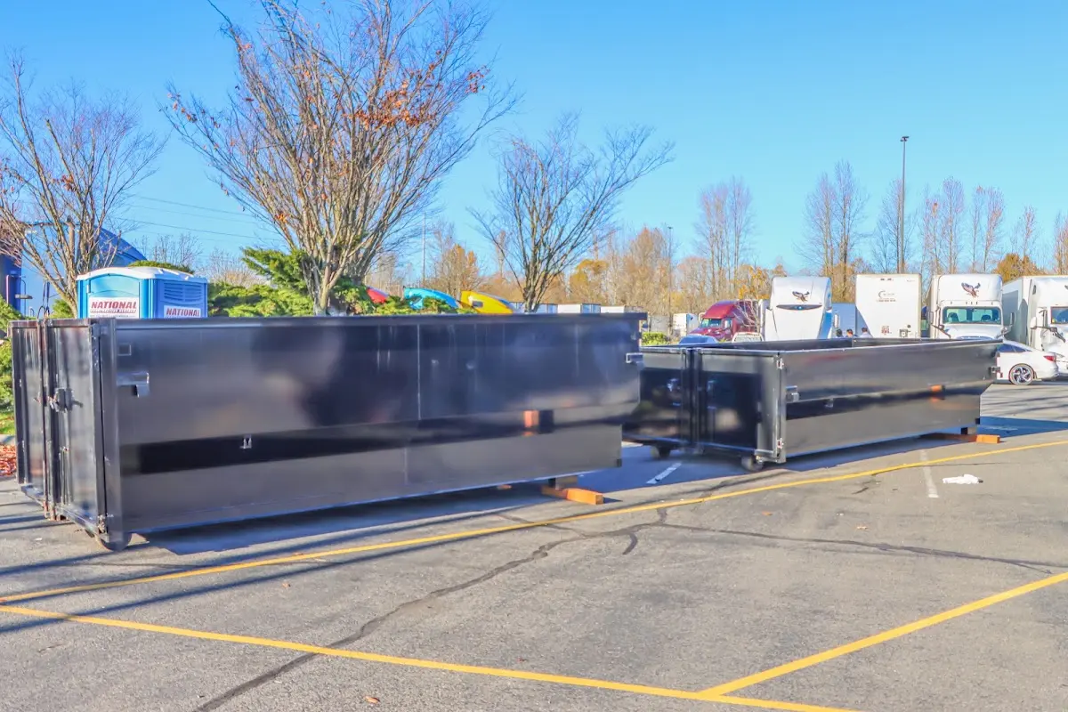 Professional dumpster rental service with roll-off container on residential driveway in Redland